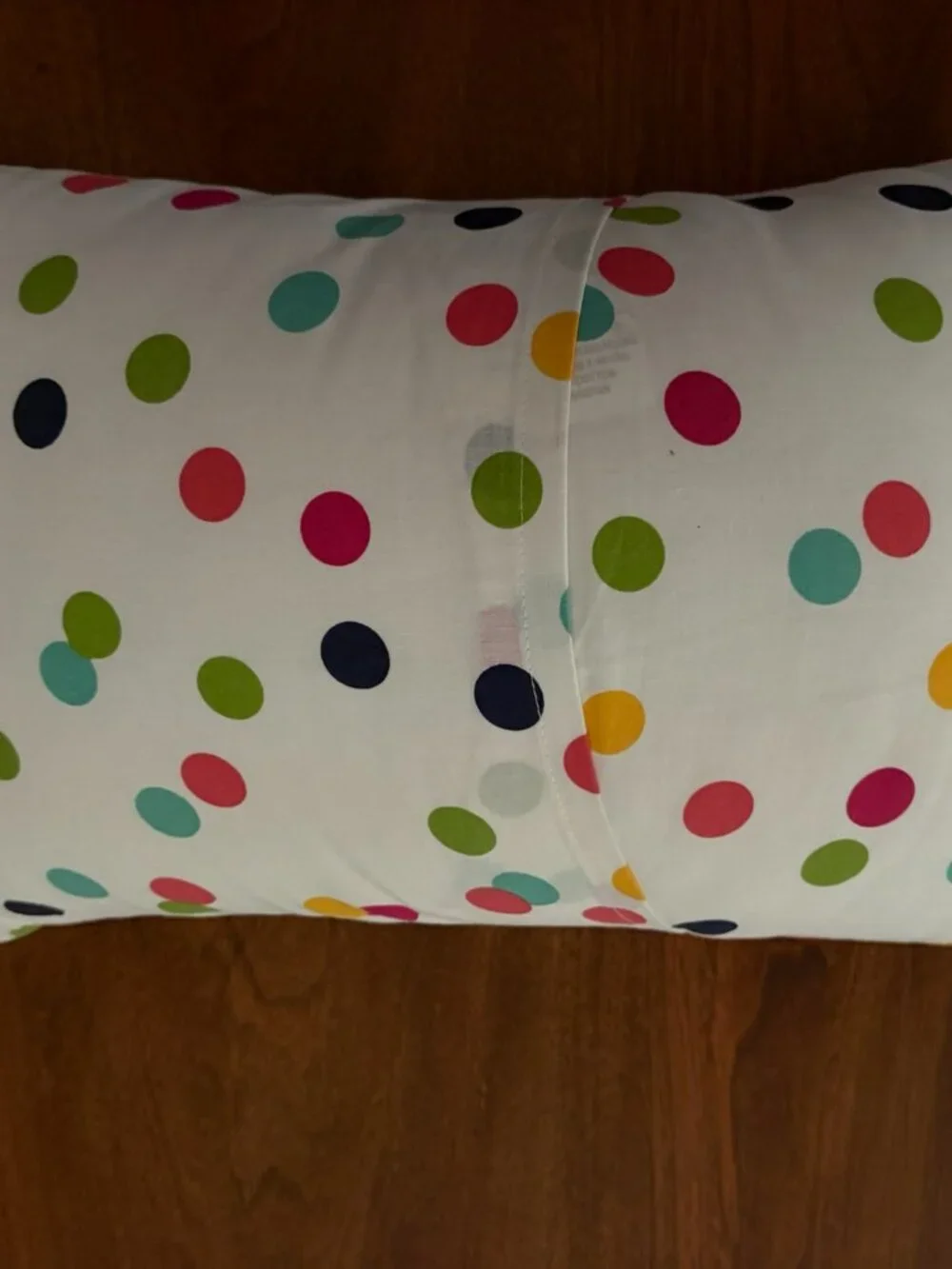 Decorative pillow with white polka dotted removable case